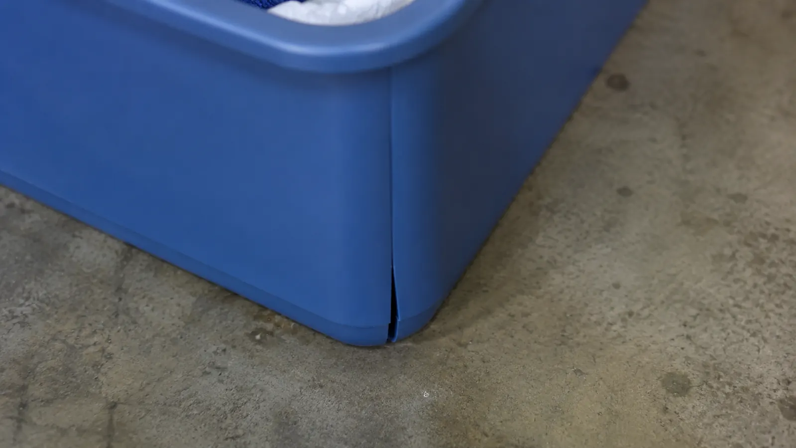 Close-up of a small separation starting at the bottom seam corner of the plastic caddy
